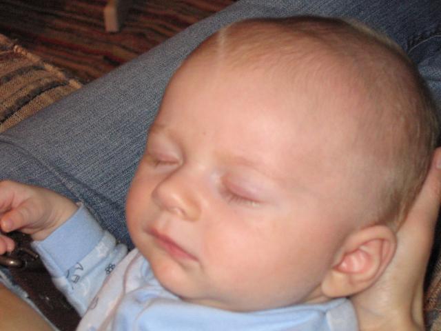 Aidan sleeps peacefully on his Mommy's lap.