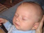 Aidan sleeps peacefully on his Mommy's lap.